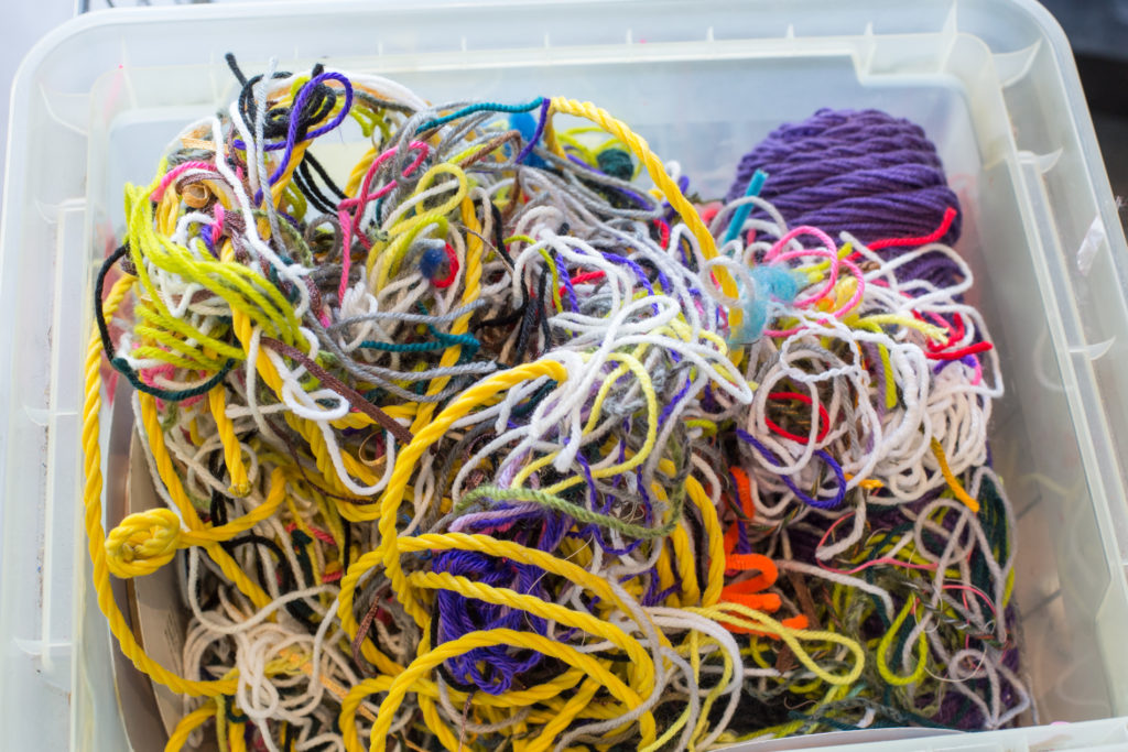 image of colorful thread and strings in a plastic bin